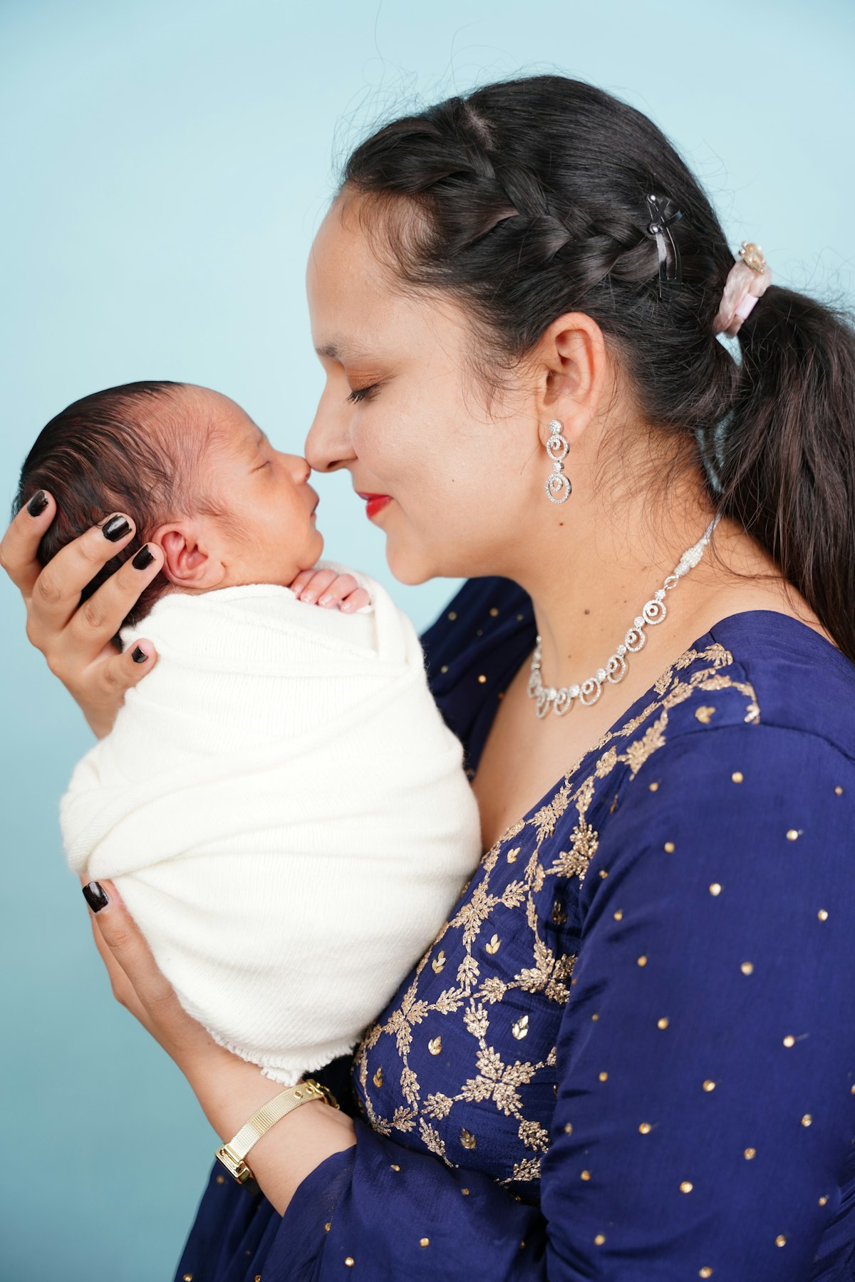 A mother holding her newborn close